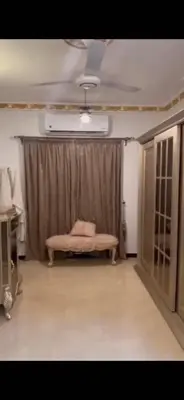 a room with a pink bed in front of a curtain at Poseidon Apartments in Hurghada