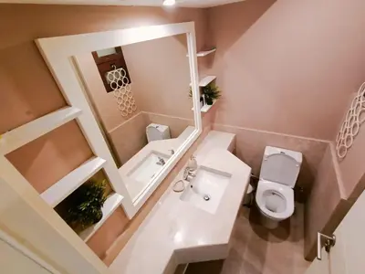 a small bathroom with a toilet and a sink at Cozy Lagoon Escpae-1Bdr Retreat in Hurghada
