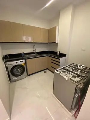 a small kitchen with a sink and a stove at Private apartment in Hurghada