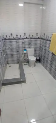 a bathroom with a white toilet in a stall at Habob Nubian Guest House in Aswan