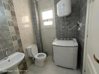 a small bathroom with a toilet and a sink at مدينة ناصر غرب أسيوط