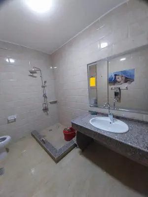 a bathroom with a sink and a toilet and a mirror at فيلا مبارك الغردقه البحر الاحمر in Hurghada