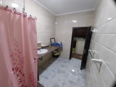 a bathroom with a sink and a shower curtain at فيلا مبارك الغردقه البحر الاحمر in Hurghada