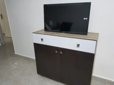 a flat screen tv on top of a dresser at Oasis compound in Hurghada