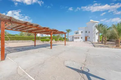 an empty parking lot in front of a white building at Beautiful 4 BDR Villa With Private Pool in Hurghada
