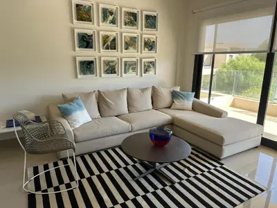 a living room with a couch and a table at G cribs cozy 1bd apartment in El Gouna