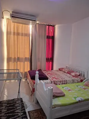 a bedroom with two beds and a window at Desert pearl in Hurghada