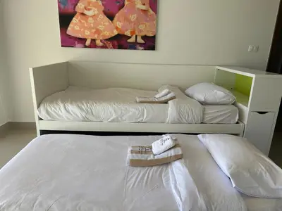 a bedroom with two beds with towels on them at G cribs cozy studio in El Gouna