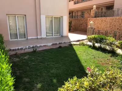 a yard in front of a house with a lawn at Sunset Pearl Sahl Hashesh in Hurghada