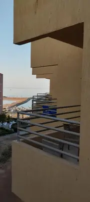 a building with a view of the ocean and a beach at Fiesta resort in Hurghada