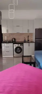a kitchen with a pink bed in a room at Fiesta resort in Hurghada