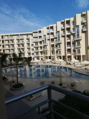 a large apartment building with a large swimming pool at Princess Resort in Hurghada