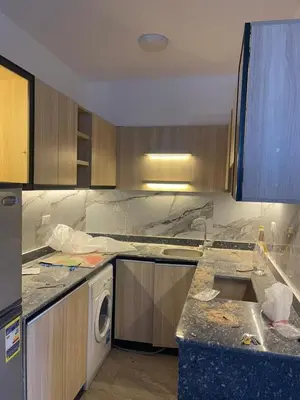 a kitchen with marble counter tops and a dishwasher at شقة مبارك in Hurghada