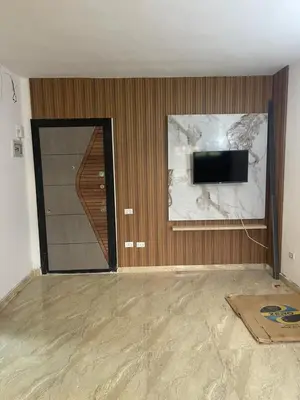 a room with a door and a tv and a wall at شقة مبارك in Hurghada