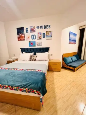 a bedroom with a large bed and a couch at Hurghada Studios in Hurghada