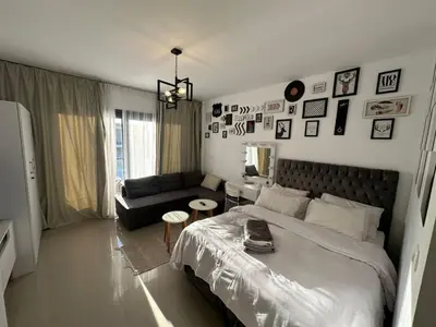 a bedroom with a large bed and a couch at Elgouna G cribs b-7 first floor in Hurghada