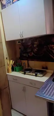 a kitchen with a stove and a white cabinet at Sun City in Aswan