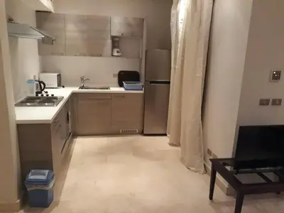 a kitchen with a sink and a refrigerator at elgouna scarab es first floor in El Gouna
