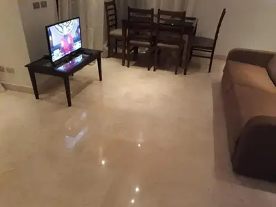 a living room with a couch and a television on a table at elgouna scarab esf in Hurghada