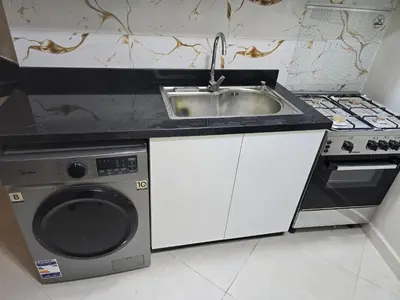 a kitchen with a sink and a washing machine at Sheraton - New & Stylish Flat in Hurghada