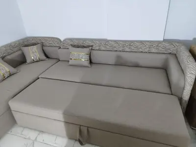 a gray couch with pillows on it in a room at Cozy Modern Apartament in Hurghada