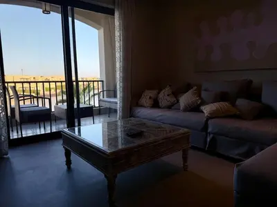 a living room with a couch and a coffee table at Panoramic 2BR Apt-Free Pool And Lagoon Access At ElGouna in Hurghada