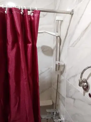 a shower with a red shower curtain in a bathroom at Tiba Golden Resort Hurghada in Hurghada
