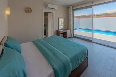 a bedroom with a bed and a view of a pool at Luxury 2 Bedrooms in Bali - Elgouna with pool in Hurghada