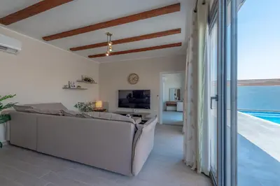 a living room with a couch and a television at Luxury 2 Bedrooms in Bali - Elgouna with pool in Hurghada