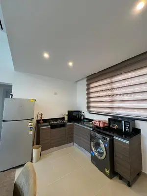 a kitchen with a refrigerator and a washing machine at Luxury Stays in G-Cribs El Gouna in El Gouna