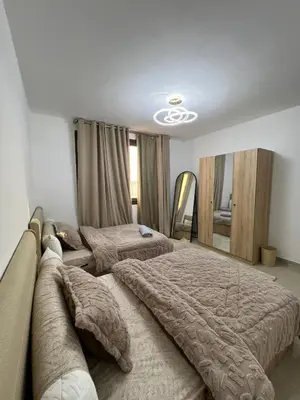 a bedroom with two beds and a couch at Luxury Stays in G-Cribs El Gouna in El Gouna