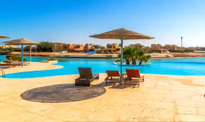 a resort with a pool with chairs and umbrellas at Luxury Stays in Sabina El Gouna in Hurghada