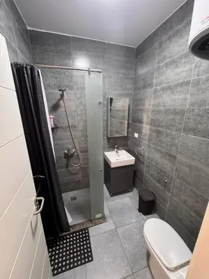 a bathroom with a shower and a toilet and a sink at Studio 511 imperial resort in Hurghada