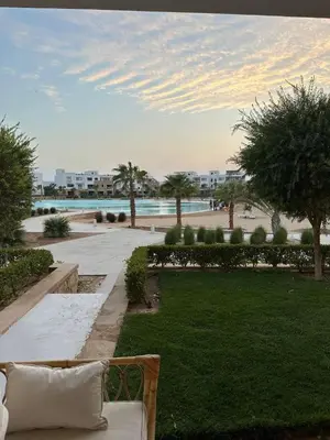 a bench in a park with a view of the ocean at Ground Modern Apartment in Hurghada