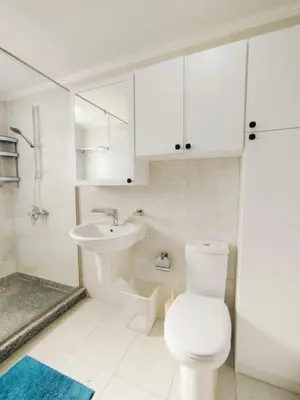 a white bathroom with a toilet and a sink at Breeze, Golf & Sea, 2 BR Luxury Apt with Terrace, Somabay in Hurghada
