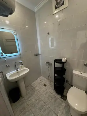 a bathroom with a white toilet and a sink at Aqua Palms Resort Hurghada in Hurghada