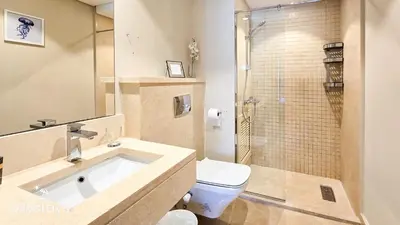 a bathroom with a sink and a toilet and a shower at Ollystays Mangroovy Seaview 1BR Beach and Pool Free access in Hurghada