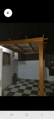 a loft bed in a room with a checkered floor at Lotus compound front of sindbad hotel in Hurghada