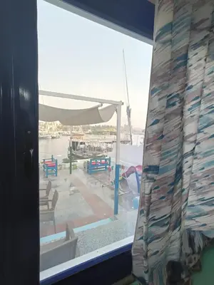 a window with a view of a marina at New El Amin Guesthouse in Aswan