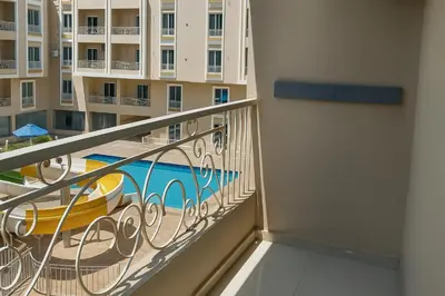 a balcony of a building with a swimming pool at Hurghada HUB Resort in Hurghada