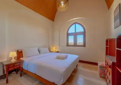 a bedroom with a large bed and a window at Luxury Stays in Nubia El Gouna in Hurghada