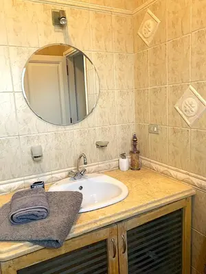 a bathroom with a sink and a mirror at Coral Blue 'An expansive spacious 4 bedroom villa in El Gouna' in Hurghada