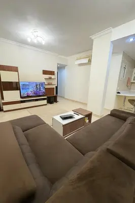 a living room with a couch and a flat screen tv at Modern apartments by the Red Sea in Hurghada