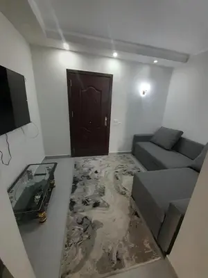 a living room with a couch and a door at منتجع سكانديك الغردقة in Hurghada