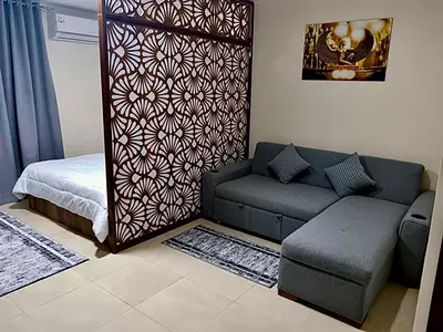 a living room with a couch and a bed at Hurghada Studio Tiba Golden Resort in Hurghada