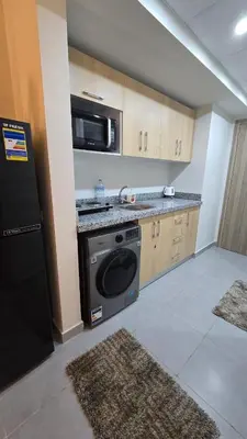 a kitchen with a washing machine and a microwave at Scandic resort chalet sea view in Hurghada
