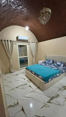 a bedroom with a bed on a marble floor at Top in Hurghada