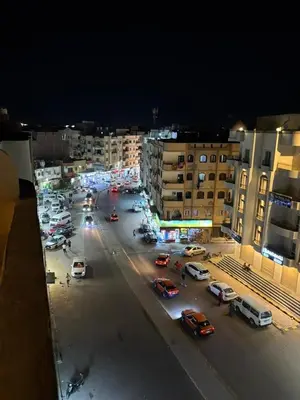 a city street with cars parked in a parking lot at Top in Hurghada