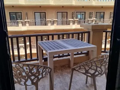 a table and two chairs on a balcony at Cozy Chalet , Turtles , Side Sea View in Hurghada