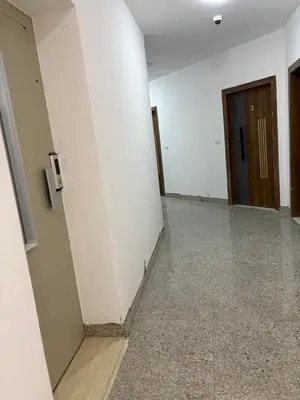 an empty hallway with white walls and a door at La Prestigia chalet in Hurghada